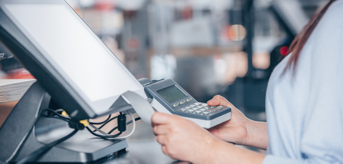 Cashier Using a POS Terminal 